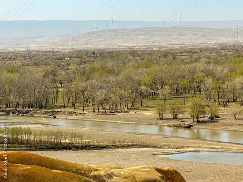 Stunning landscape of Wucaitan (Five Colored Hills) and the Irtysh River in Burqin, Xinjiang, China.