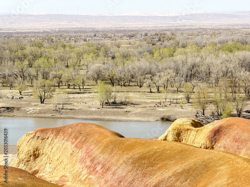 Stunning landscape of Wucaitan (Five Colored Hills) and the Irtysh River in Burqin, Xinjiang, China.