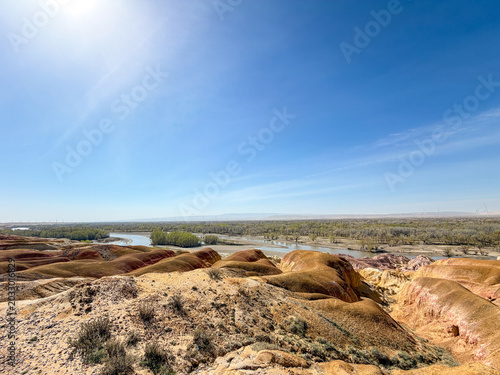 Stunning landscape of Wucaitan (Five Colored Hills) and the Irtysh River in Burqin, Xinjiang, China.