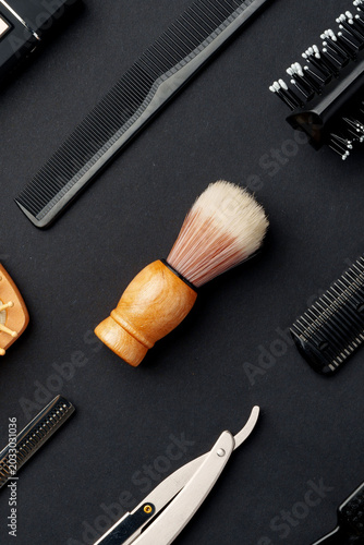 Obraz na płótnie Tools for grooming hair and beard on a dark surface in a barbershop setting