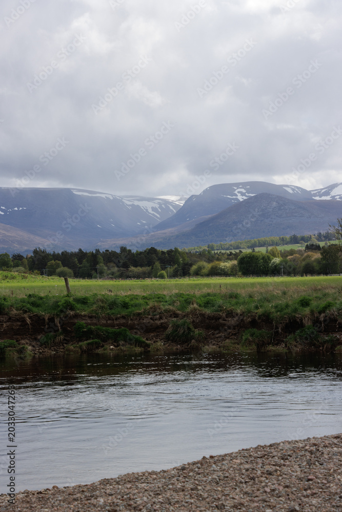 Fototapeta premium River Spey flowing through valley with Lairig Ghru mountain pass in background, Aviemore, Scotland