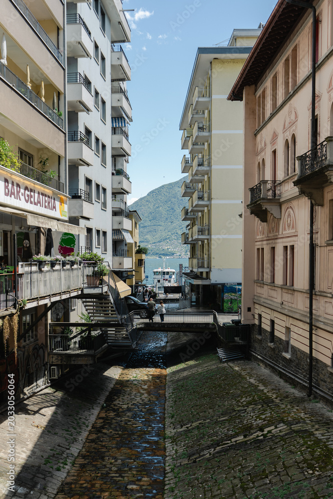 Fototapeta premium Panoramic view of Locarno in Ticino, Switzerland, surrounded by the majestic Alps. Beautiful cityscape and mountain scenery in the Italian-speaking region of Switzerland.
