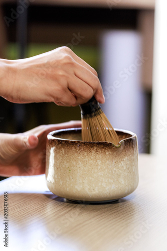 Preparing Matcha Green Tea With Bamboo Whisk