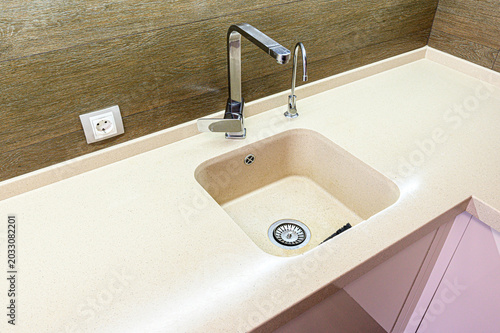 Tableau sur toile beige artificial stone countertop integrates a square undermount sink with a chr
