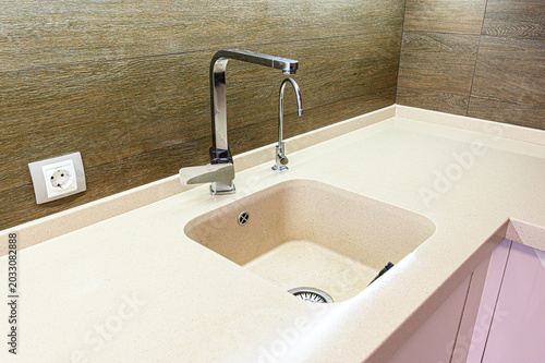 Φωτογραφία beige artificial stone countertop integrates a square undermount sink with a chr