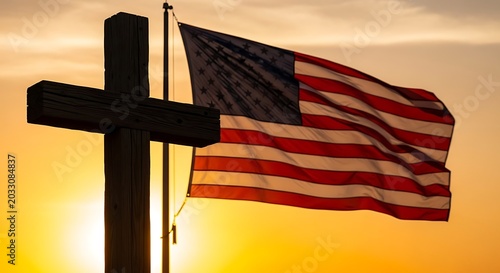 Silhouette of a wooden cross and a waving flag against a golden sunset