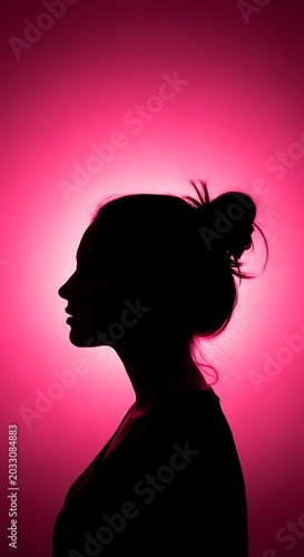 Silhouette of a woman's profile against a vibrant pink gradient background