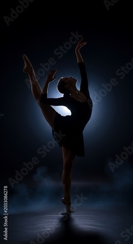 Silhouette of graceful dancer in dark studio, illuminated by spotlight, in dynamic pose