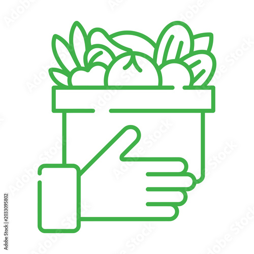 Hand holding a bag filled with fresh produce, vegetables, and leaves, healthy organic food concept isolated.