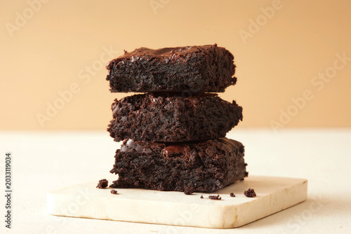Fotografía Delicious Dessert Snack With Stacked Chocolate Brownies on a White Surface With
