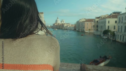 A tranquil scene featuring a person gazing out over a picturesque canal, surrounded by charming architecture. The soft light enhances the peaceful atmosphere, inviting contemplation and appreciation o
