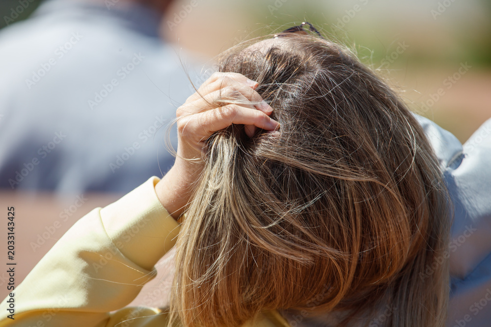 Fototapeta premium Woman gently touches her hair