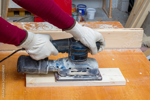 Εκτύπωση καμβά Woman using orbital sander on wooden board in workshop