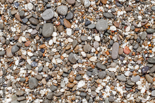 background of wet pebbles on the beach close-up