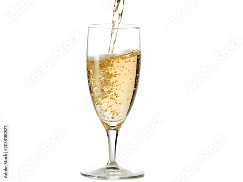 Chilled sparkling wine being poured into a tall clear glass with golden bubbles transparent background