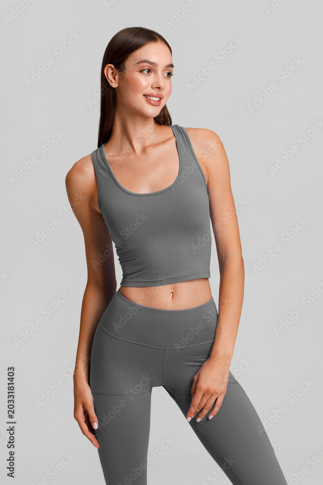 Obraz premium Athletic girl on the gray background. Fitness woman