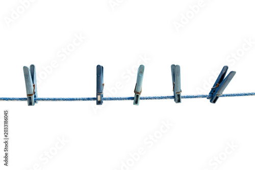Minimalist blue plastic clothespins aligned on clothesline household concept