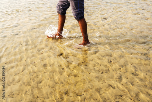young man walking on the beach