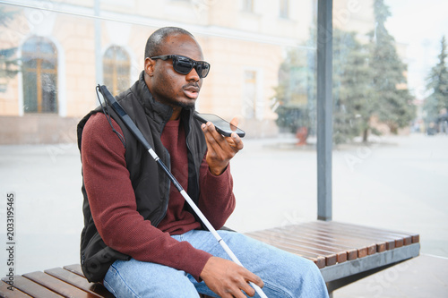 Cuadro en lienzo African american blind man using smartphone voice assistant