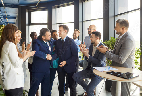 Εκτύπωση καμβά Happy businessman introduce new male employee worker during group meeting in mod