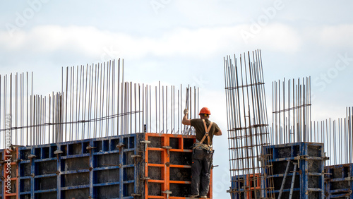 Worker stands atop steel-reinforced formwork