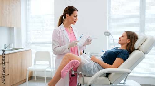 Doctor explains medical procedure to patient in examination room