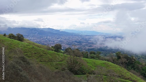 Drone reveal shot of San Jose city view from the green mountains of Coronado, Costa Rica