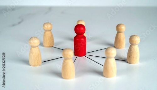 Red wooden figure connected by lines to surrounding natural wood figures on a gray background, symbolizing leadership, teamwork, and network communication.