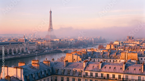 Parisian cityscape at dawn, with the Eiffel Tower visible in the distance