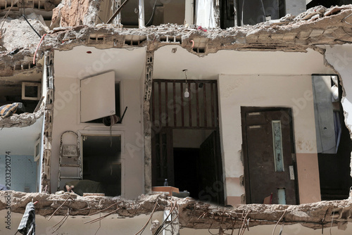 Slika na platnu A heavily damaged and partially destroyed residential house stands in ruins in the southern suburbs of Beirut Lebanon bearing the catastrophic toll of devastating Israeli military airstrikes