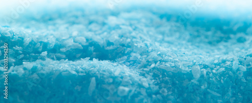 Tableau sur toile Close-up view of blue salt crystals on a flat surface in a bright light