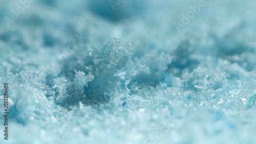 Photos Close-up view of blue salt crystals on a flat surface in a bright light