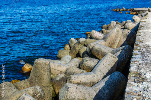 Breakwater made of the tetrapods in sea. Coastal defence barrier