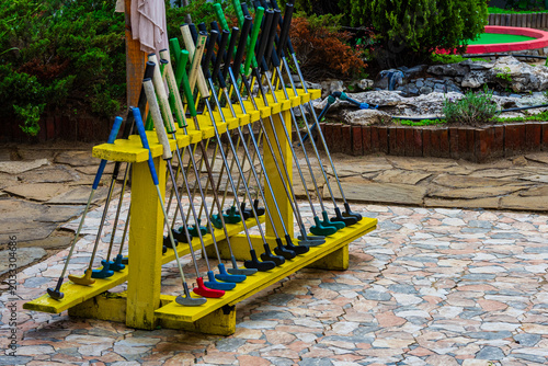 Many golf clubs at the mini golf course