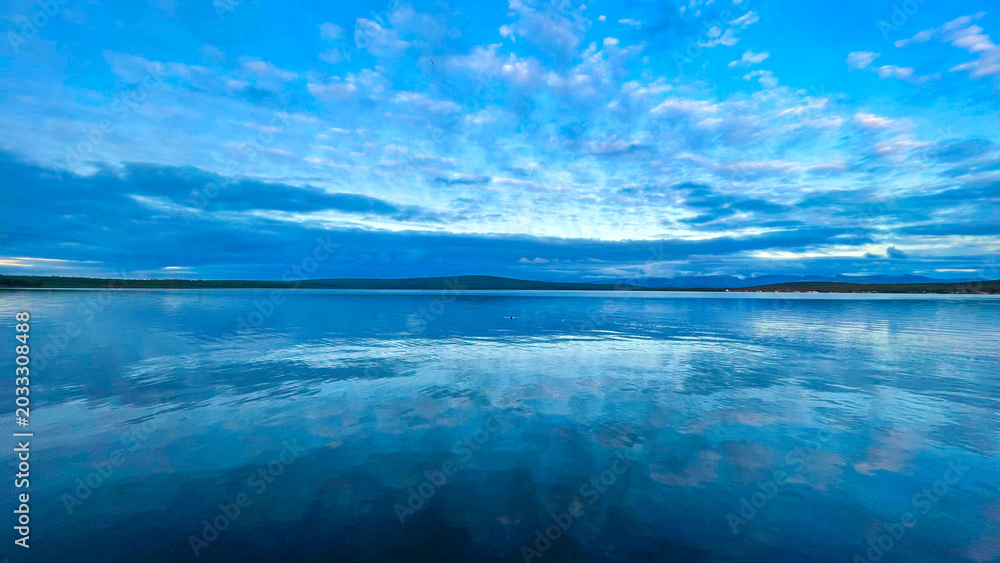Fototapeta premium Mirror-Like Water Reflections Under Blue Cloudy Sky – Minimalist Coastal Seascape Panorama
