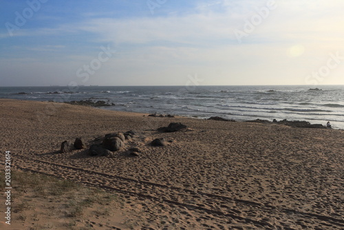 A beach with rocks and water