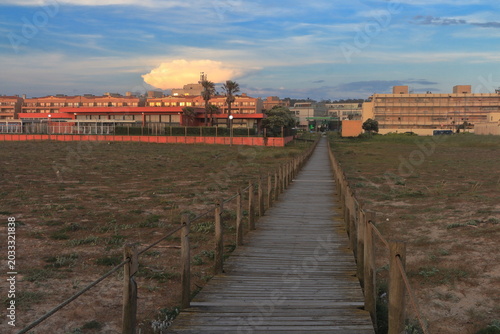 A wooden walkway leading to a beach