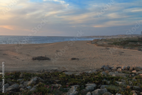 A rocky beach with water and sand