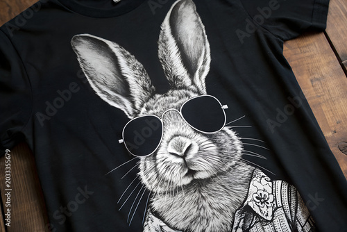A highly detailed black and white illustration of a rabbit  wearing stylish sunglasses, centered on a dark background t-shirt design 
