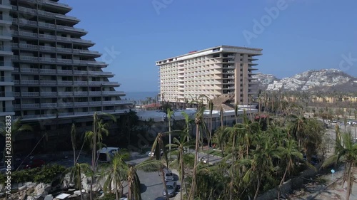 Acapulco, Guerrero, Mexico - October 30 2023: Aerial drone footage showing damaged hotels, destroyed palm trees and urban destruction after Hurricane Otis impacted the coastal tourist city of Acapulco