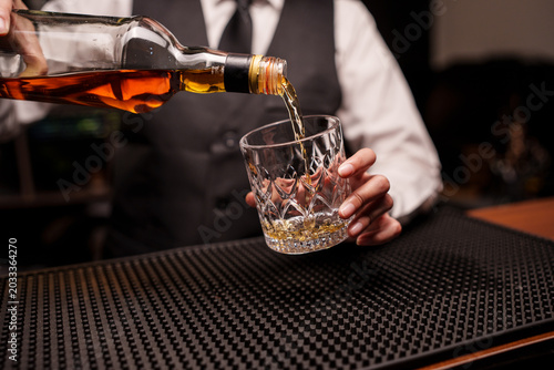 Bartender Pouring Whiskey into a Glass