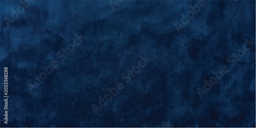 An old dark blue grunge concrete wall texture with a rough black stone surface and vintage paper pattern creates a blank dirty backdrop for a weathered design