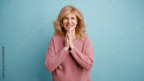 Canvastavla Senior woman smiling, making a thankful or pleading gesture, feeling hopeful on