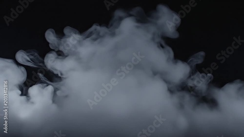 Smoke rising on black background.