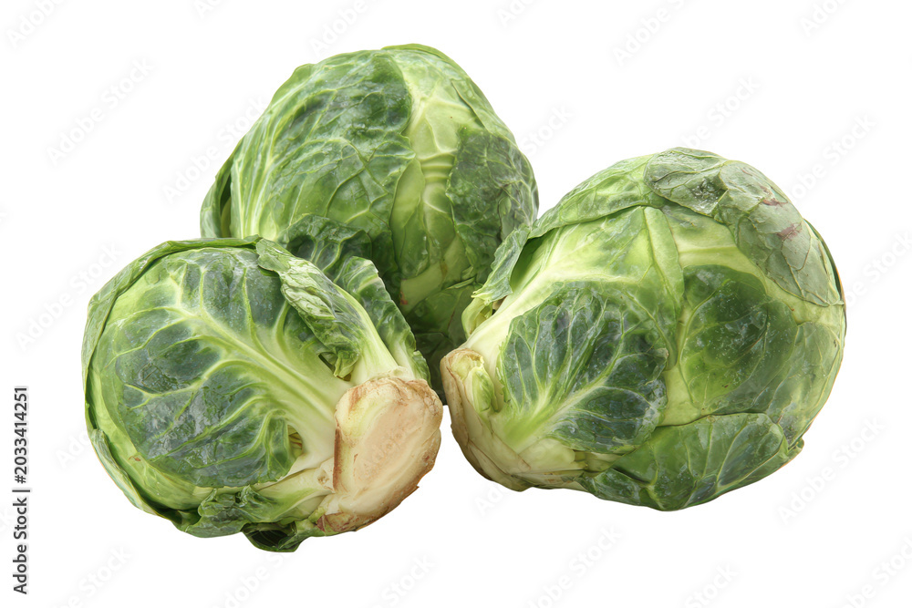 Obraz premium Three fresh green Brussels sprouts with visible leaves and stems on black background vegetable