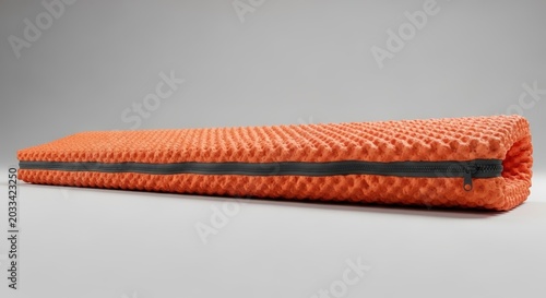 Vibrant orange coiled rope isolated background.