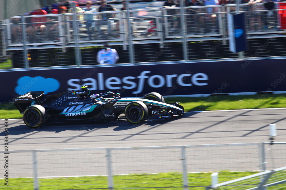 Obraz premium May 24, 2026, Montreal, Canada, Mercedes F1 car racing through Circuit Gilles Villeneuve corner. g.