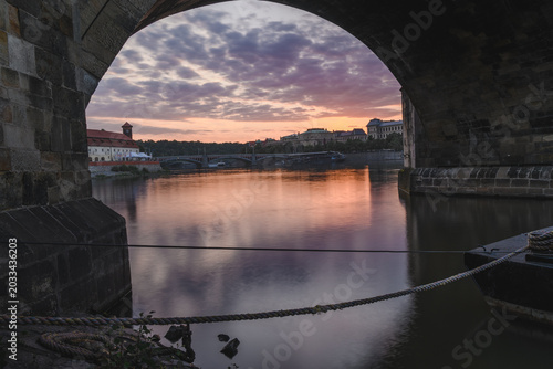 Sunset Glow Framed Beneath a Prague Bridge