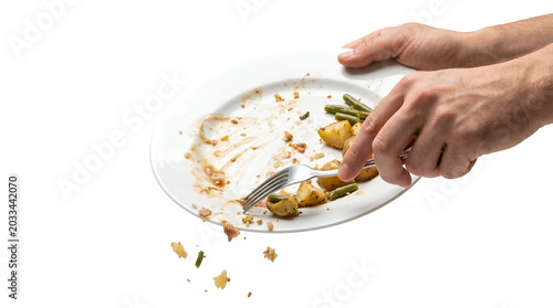 Hand throwing leftover food from the meal on a plate on transparent background Environmentally responsible, food waste concept