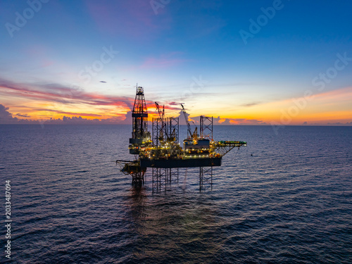 Aerial View of Offshore Jack-Up Rig and Production Platform at Sunset. Offshore Energy Exploration and Production.